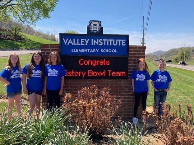 VIES History Bowl Team in front of the school sign