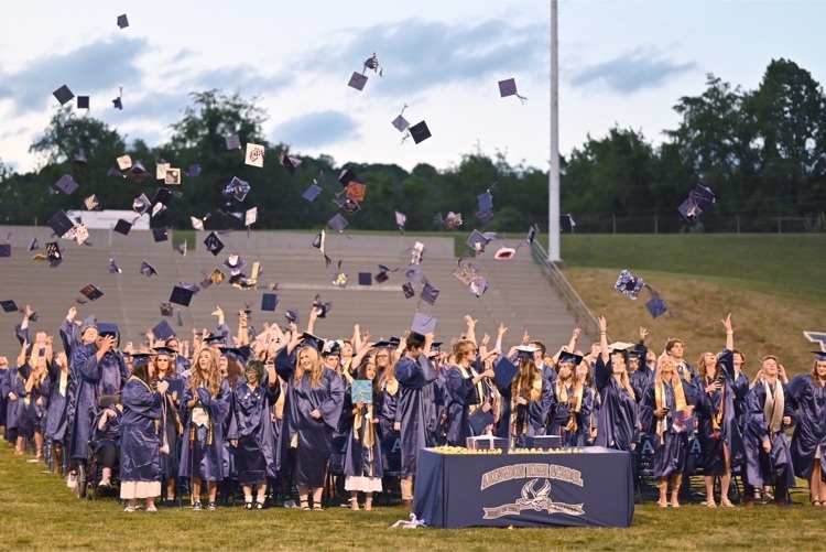 graduates tossing caps.