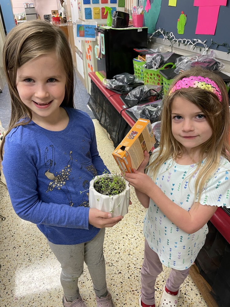 Students from MES holding plants they are growing