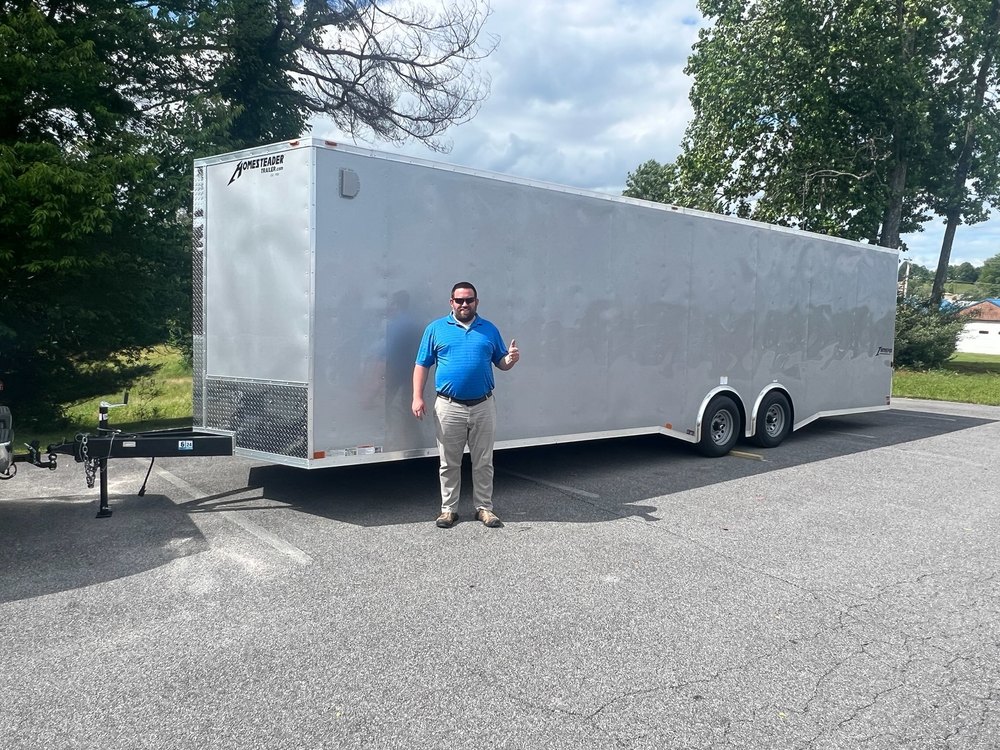 Mr. Andrew Smith standing in front of the trailer to be used for the Mobile STEM Lab